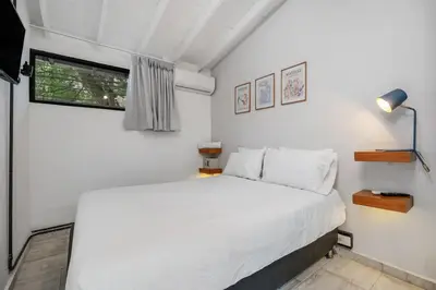 a bedroom with a white bed and a window at GAIRA - Provenza Walkable Area, AC & Balcony facing KarolG club in Medellín