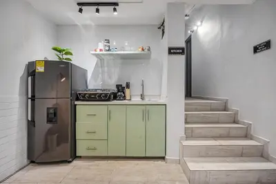 a kitchen with a refrigerator and a staircase at GAIRA - Provenza Walkable Area, AC & Balcony facing KarolG club in Medellín