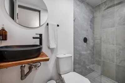 a bathroom with a sink and a toilet and a mirror at GAIRA - Provenza Walkable Area, AC & Balcony facing KarolG club in Medellín