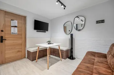 a room with a table and a couch and a mirror at GAIRA - Provenza Walkable Area, AC & Balcony facing KarolG club in Medellín