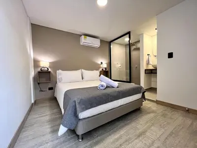 a bedroom with a large bed in a room at BALI - AC & Heated Pool in Provenza in Medellín