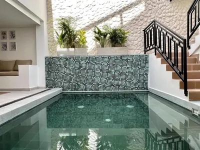 a pool in a house with green tiles at BALI - AC & Heated Pool in Provenza in Medellín