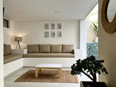 a living room with a couch and a table at BALI - AC & Heated Pool in Provenza in Medellín