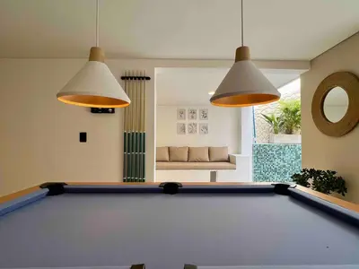 a pool table in a living room with two lights at BALI - AC & Heated Pool in Provenza in Medellín