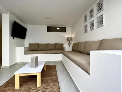 a living room with a couch and a table at BALI - AC & Heated Pool in Provenza in Medellín