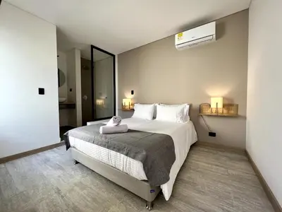 a bedroom with a large bed with a towel on it at BALI - AC & Heated Pool in Provenza in Medellín