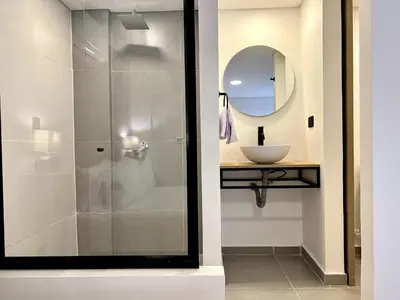 a bathroom with a shower and a sink at BALI - AC & Heated Pool in Provenza in Medellín