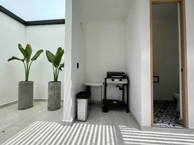 a room with a stove and two potted plants at BORA BORA - Huge Jacuzzi, Rooftop & AC in Provenza in Medellín