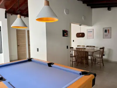 a pool table in the middle of a living room at BORA BORA - Huge Jacuzzi, Rooftop & AC in Provenza in Medellín