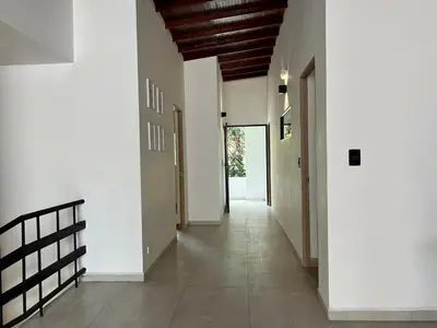 an empty hallway with white walls and a wooden ceiling at BORA BORA - Huge Jacuzzi, Rooftop & AC in Provenza in Medellín