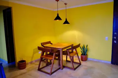 a dining room with a wooden table and chairs at Coffee Retreat Peaceful Views and Local Soul in Medellín