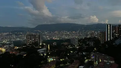 a view of a city at night with buildings at Coffee Retreat Peaceful Views and Local Soul in Medellín