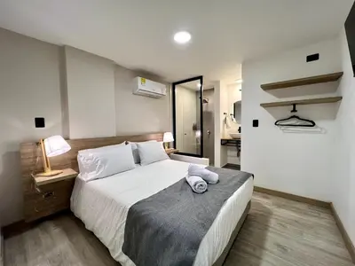 a bedroom with a large white bed in a room at FIJI - Jacuzzi & Outdoor Lounge in Provenza in Medellín