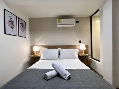 a bedroom with a bed with two towels on it at FIJI - Jacuzzi & Outdoor Lounge in Provenza in Medellín