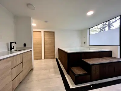 a large bathroom with a tub and a screen at FIJI - Jacuzzi & Outdoor Lounge in Provenza in Medellín