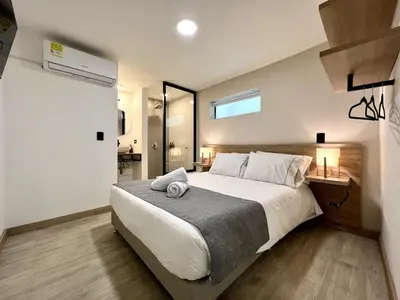 a bedroom with a large bed and a window at FIJI - Jacuzzi & Outdoor Lounge in Provenza in Medellín