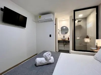 a bedroom with a bed with a towel on it at FIJI - Jacuzzi & Outdoor Lounge in Provenza in Medellín