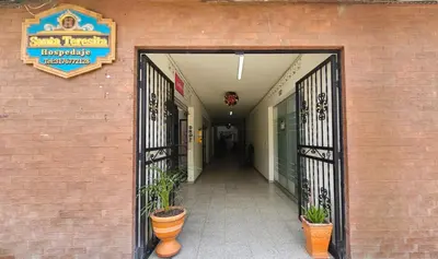 an entrance to a building with potted plants at Hospedaje Santa Teresita in Concepción