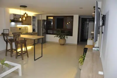 a kitchen and living room with a table and chairs at Apartamento entero cerca al Aeropuerto Internacional in Rionegro