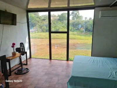 a bedroom with a bed and a view of a field at Beautiful duplex in Honda