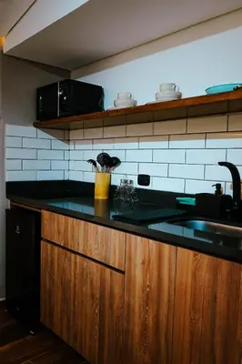 a kitchen with a black counter top and a sink at Stadium Home Shelter in Medellín