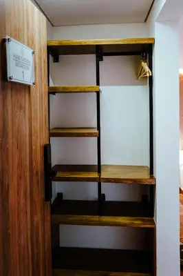 a room with wooden shelves and a door at Stadium Home Shelter in Medellín