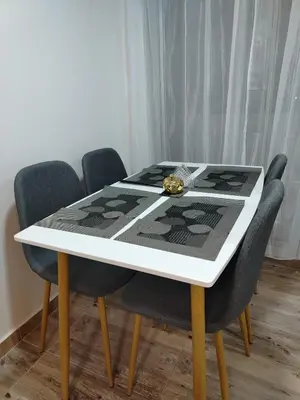 a dining room table with chairs and a black and white table at Apartamento en Manizales reserva campestre in Manizales