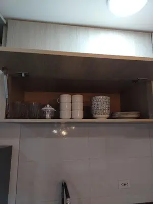 a shelf with bowls and plates on it in a kitchen at Apartamento en Manizales reserva campestre in Manizales