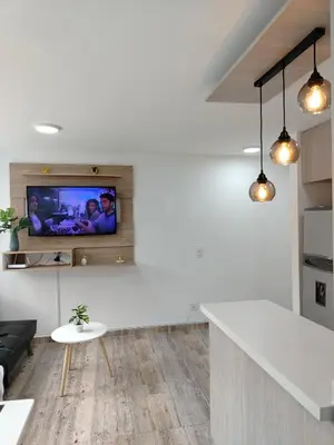 a living room with a tv on a wall at Apartamento en Manizales reserva campestre in Manizales