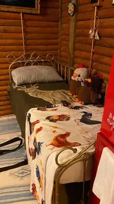 a bedroom with a bed with a comforter on it at Cabaña Caballo Dorado in Guarne