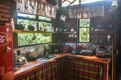 a kitchen with a sink and a counter with a window at Cabaña Caballo Dorado in Guarne
