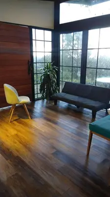 a living room with a couch and a chair at Chalet las palmas Poblado in Medellín