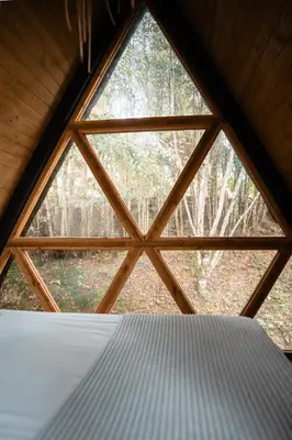 a large window in a room with a bed at Onirico Luxury in Medellín