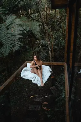 a woman sitting on a bed on a blanket at Onirico Luxury in Medellín