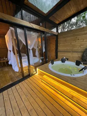 a room with a jacuzzi tub on a wooden deck at Onirico Luxury in Medellín