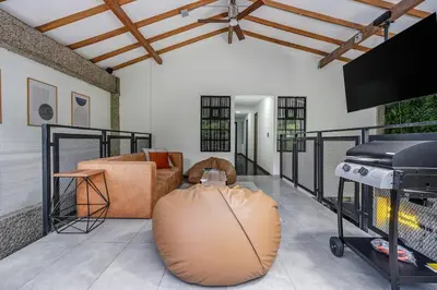 a living room with a couch and a grill at TERRA - Heated Small Pool, BBQ & AC Lleras Park in Medellín