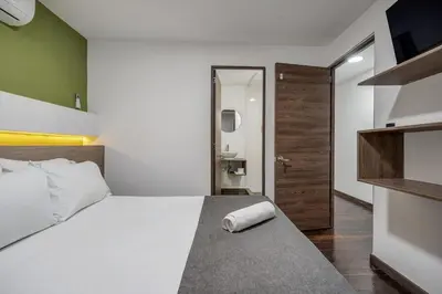 a bedroom with a large bed with a towel on it at TERRA - Heated Small Pool, BBQ & AC Lleras Park in Medellín