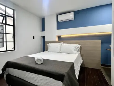 a bedroom with a bed with a hat on it at ARYA - Huge Hot Tub & AC Steps from Lleras Park in Medellín