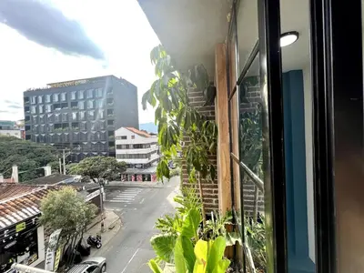 a view of a street from a window with plants at ARYA - Huge Hot Tub & AC Steps from Lleras Park in Medellín