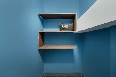 a shelf with a clock on a blue wall at ARYA - Huge Hot Tub & AC Steps from Lleras Park in Medellín