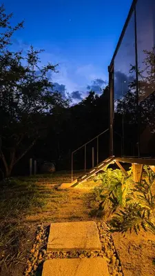 a building with lights on the side of it at Cabaña 35min de Medellín, Benevento Reserva Botánica in Girardota