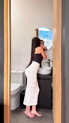 a woman standing in front of a bathroom mirror at Cabaña 35min de Medellín, Benevento Reserva Botánica in Girardota