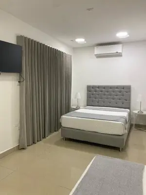 a bedroom with a bed and a television in it at Apartahotel Provenza in Medellín