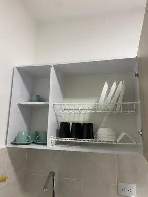 a kitchen with white plates and dishes on shelves at Apartahotel Provenza in Medellín