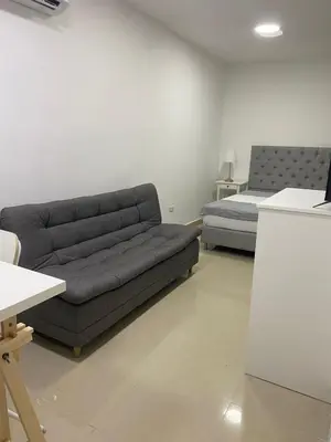 a living room with a couch and a bed at Apartahotel Provenza in Medellín