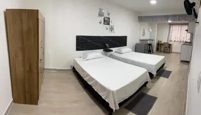 a room with two beds in a room at Apartamento amoblado en Belén in Medellín