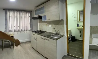 a small kitchen with a sink and a stove at Apartamento amoblado en Belén in Medellín