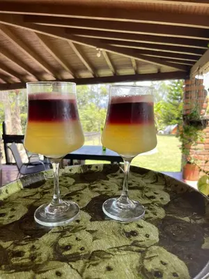 two wine glasses sitting on top of a table at Encanto Verde cabaña sencilla in Marinilla
