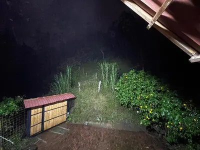 a garden at night with a fence and plants at Glamping Manzara in Manizales
