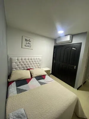 a bedroom with a bed and a black door at Apartasol Santafe de Antioquia in Santa Fe de Antioquia